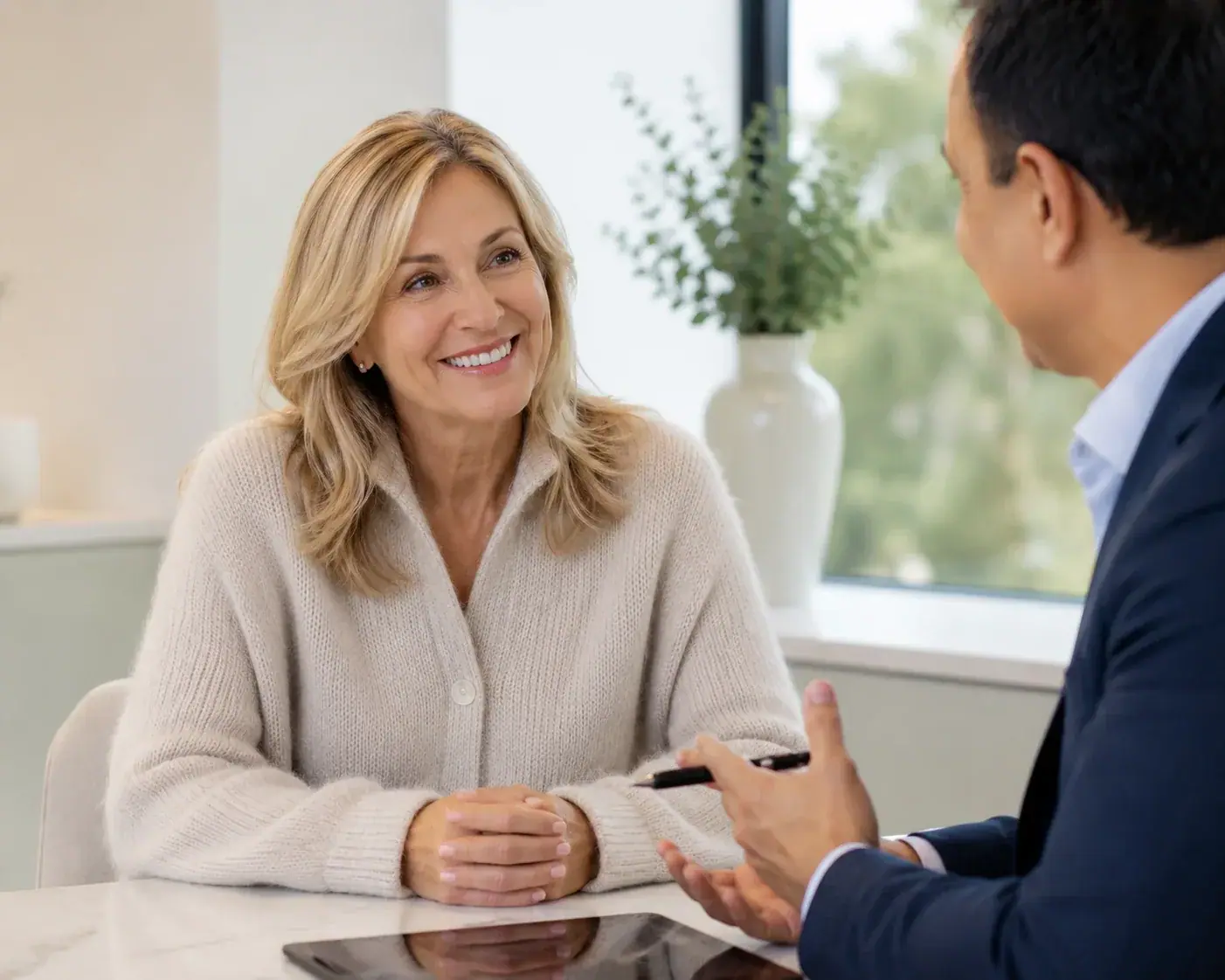 Smiling patient during a consultation at Smiles By Jiveh